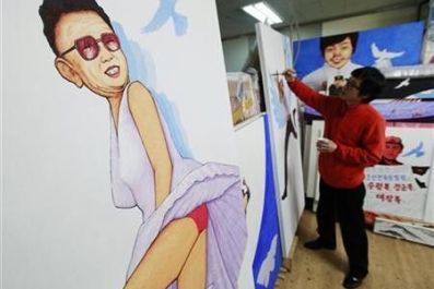 North Korean defector and artist Song Byeok paints next to another work of his, titled &#039;&#039;Marilyn Monroe&#039;&#039;, which satirizes North Korean leader Kim Jong-il, at his atelier in Seoul