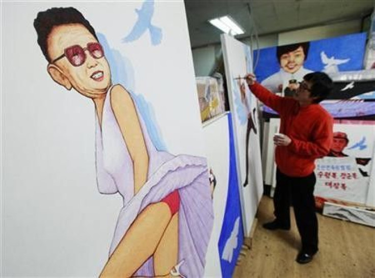 North Korean defector and artist Song Byeok paints next to another work of his, titled &#039;&#039;Marilyn Monroe&#039;&#039;, which satirizes North Korean leader Kim Jong-il, at his atelier in Seoul