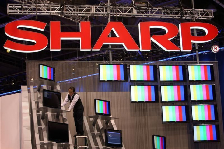 A worker prepares a display of Sharp flat panel televisions for the 2009 International Consumer Electronics Show (CES) at the Las Vegas Convention Center in Las Vegas.