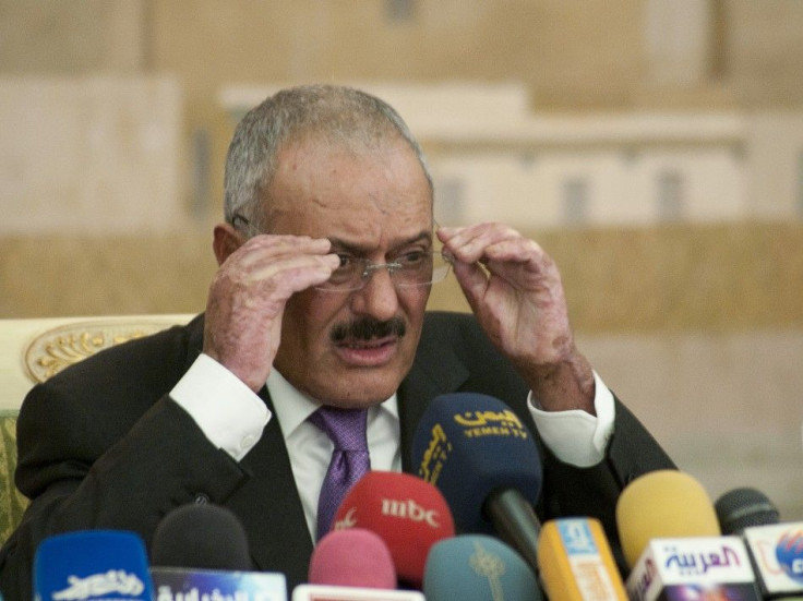 Yemen's outgoing President Ali Abdullah Saleh adjusts his spectacles during a news conference in Sanaa