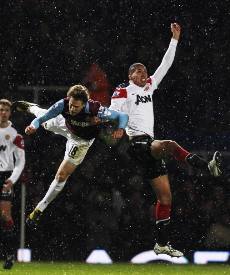 West Ham United's Spector challenges Manchester United's Smalling during their English League Cup soccer match at Upton Park in London.