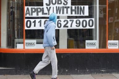 A man walks past a shop advertising job vacancies in Leicester
