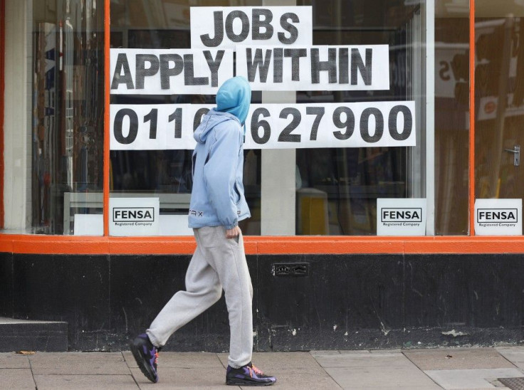 A man walks past a shop advertising job vacancies in Leicester