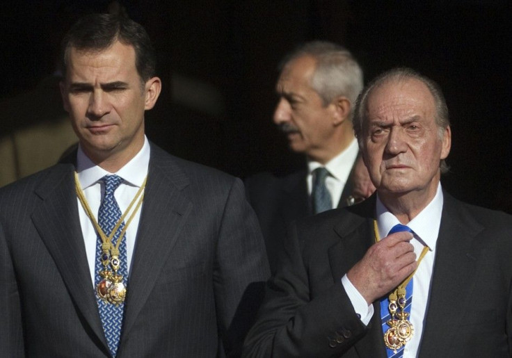 Spain's Crown Prince Felipe and Spain's King Juan Carlos watch military parade outside the Parliament in Madrid