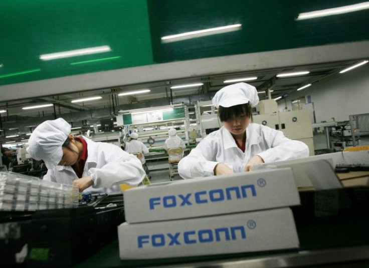 Employees work inside a Foxconn factory in the township of Longhua in the southern Guangdong province in this May 26, 2010 file photo.