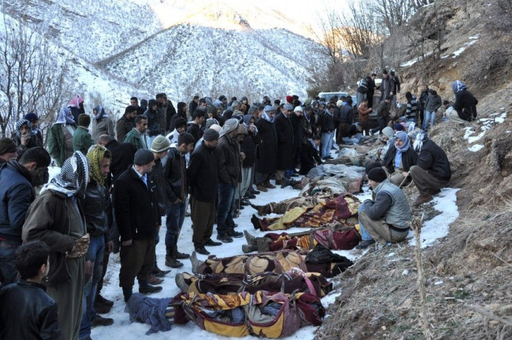 Locals gather around bodies of people who were killed in air strikes in Ortasu village near the southeastern Turkish town of Sirnak