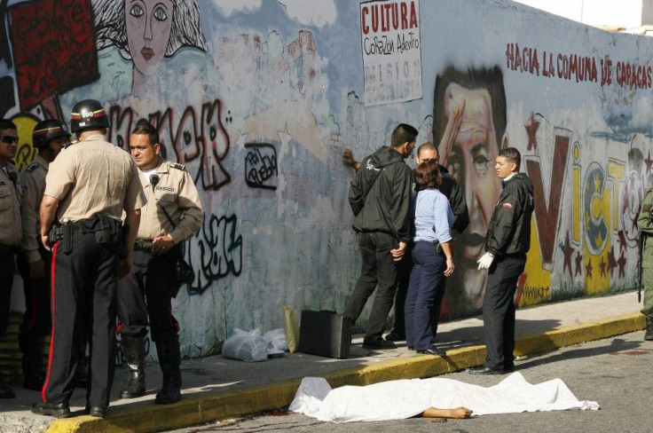 The body of a man lies on the street after he was shot dead when he tried to rob a policeman dressed in plain clothes in Caracas