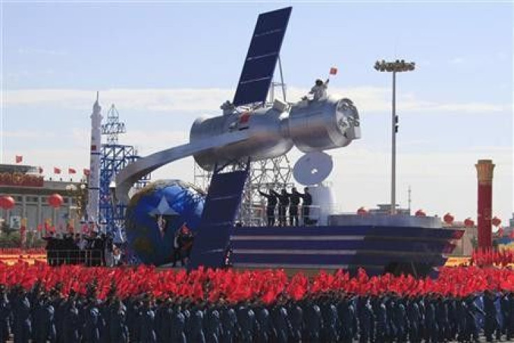 A float with a model featuring satellite is displayed during a parade to mark the 60th anniversary of the founding of the People&#039;s Republic of China, in Beijing October 1, 2009.