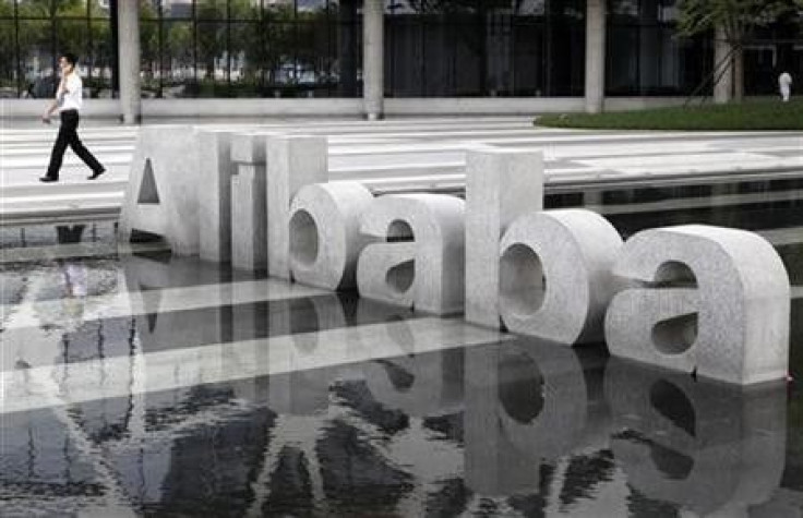 A man walks past a logo of Alibaba (China) Technology Co. Ltd at its headquarters on the outskirts of Hangzhou, Zhejiang province