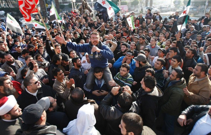 Syrian and Lebanese protesters chant slogans against Syrian President Bashar al-Assad during a protest in solidarity with Syria&#039;s anti-government protesters, in the port-city of Tripoli, in north Lebanon