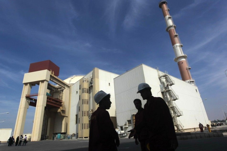 Iranian workers stand in front of Bushehr nuclear power plant, 1,200 km south of Tehran