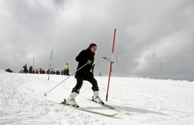 A woman learns to ski on a slope in Gulmarg 