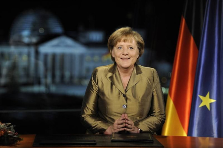 German Chancellor Merkel poses for photographs after recording of her annual New Year's speech at Chancellery in Berlin