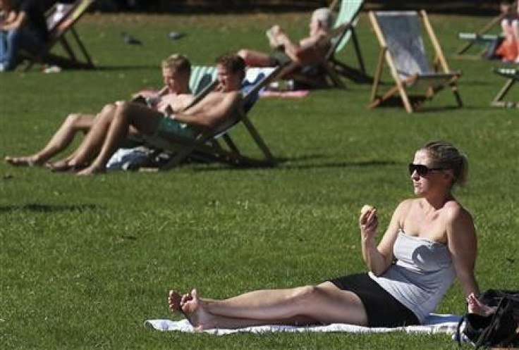 Sunbathers sit in St James&#039;s Park in central London October 2, 2011.