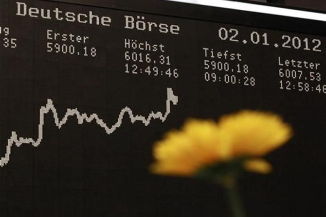 The German DAX Index board is pictured behind a plastic flower during a trading session at the first trading day at Frankfurt&#039;s stock exchange in Frankfurt