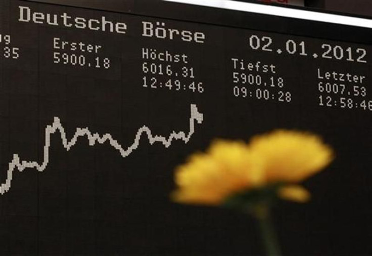 The German DAX Index board is pictured behind a plastic flower during a trading session at the first trading day at Frankfurt&#039;s stock exchange in Frankfurt