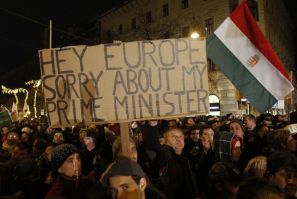 A man holds up a sign during a protest in central Budapest
