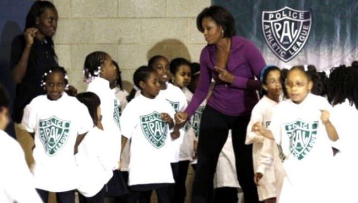  U.S. First Lady Michelle Obama dances with children at the New York Police 