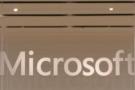 The Microsoft logo hangs from a window during the grand opening of Microsoft's first retail store in Scottsdale