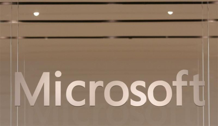 The Microsoft logo hangs from a window during the grand opening of Microsoft's first retail store in Scottsdale