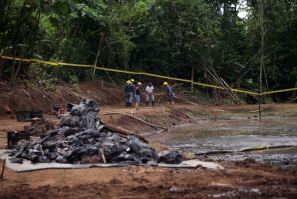 Ecuadorean Workers Clean Up and Oil Waste Pit