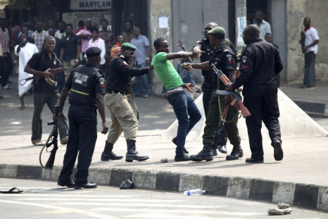 Policemen beat up a protester during a rally against fuel subsidy removal in Lagos