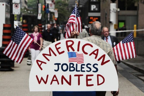 A man holds a sign reading &quot;American Jobless Wanted&quot; on the street ahead of the G20 summit in Toronto