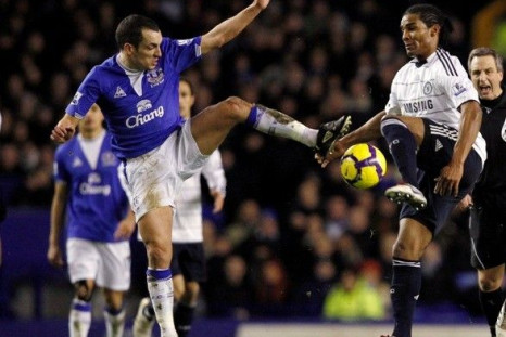 Everton's Leon Osman (L) challenges Chelsea's Florent Malouda (R)