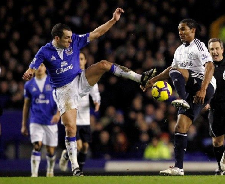 Everton's Leon Osman (L) challenges Chelsea's Florent Malouda (R)