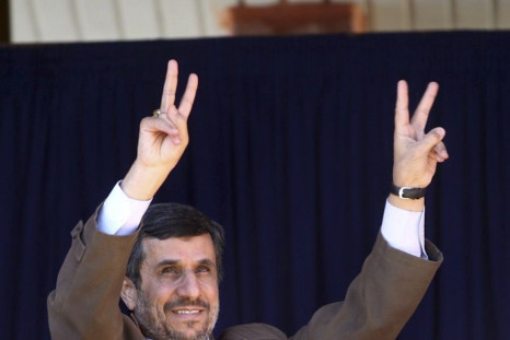 Iranian President Mahmoud Ahmadinejad flashes victory signs before speaking to his supporters