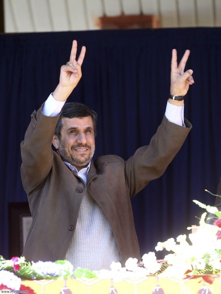 Iranian President Mahmoud Ahmadinejad flashes victory signs before speaking to his supporters