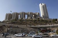 Vehicles drive past the Holyland towers apartment complex in Jerusalem