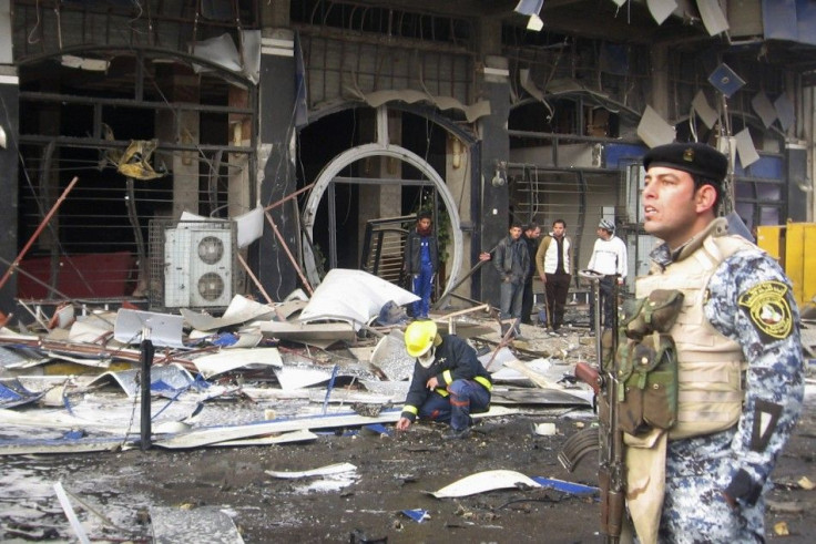 A police officer provides security at the site of a bomb attack in Baghdad&#039;s northwestern Kadhimiya district