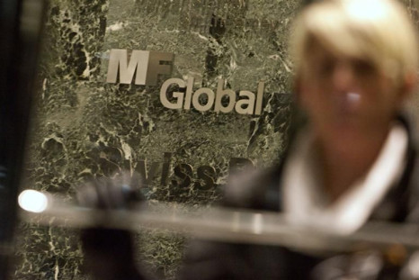 A woman leaves the office complex where MF Global Holdings Ltd have an office on 52nd Street in midtown Manhattan