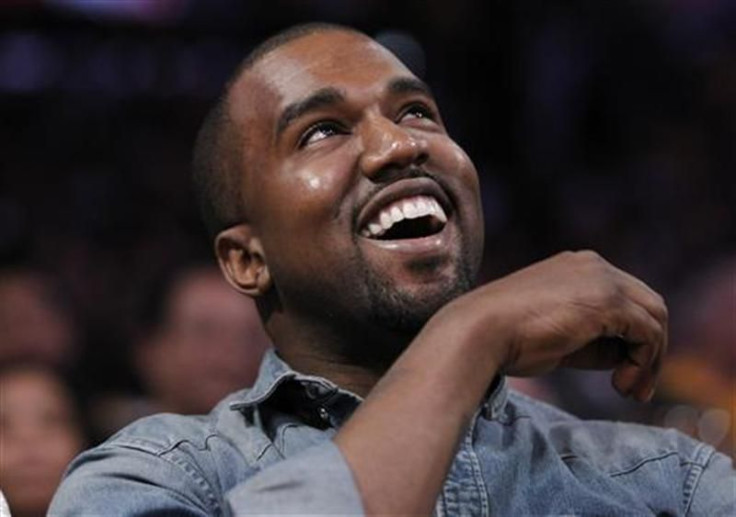 Recording artist Kanye West sits courtside as he attends the NBA basketball game between the Lakers and Bulls in Los Angeles