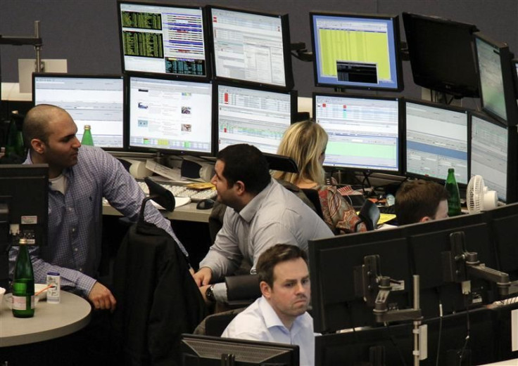 Traders are pictured at their desks at the Frankfurt stock exchange