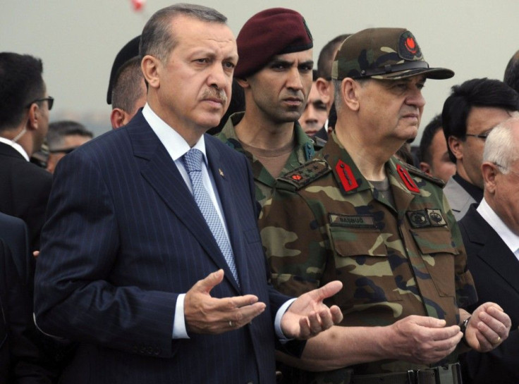 Turkish Prime Minister Erdogan and Armed Forces Chief General Ilker Basbug pray during a funeral ceremony at a military base in Van