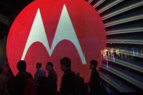 People pass by the Motorola booth during the 2011 International Consumer Electronics Show (CES) in Las Vegas