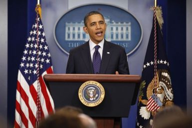 U.S. President Barack Obama speaks to the press after signing into law a two-month payroll tax cut extension at the White House in Washington December 23, 2011.