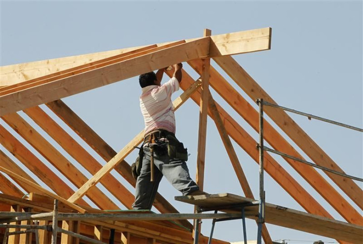 A construction worker works on the framework for a single family home currently under construction in Los Angeles