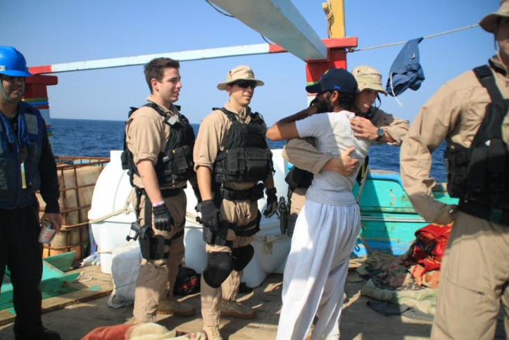 Handout photo shows a U.S. sailor from a destroyer with the USS John C. Stennis carrier strike group greeting a crew member of the Iranian-flagged dhow Al Molai after rescuing the fishing vessel from pirates in the Arabian Sea