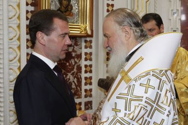 Russia&#039;s President Medvedev greets Patriarch of Moscow and All Russia Kirill as they attend an Orthodox Christmas Mass in Moscow