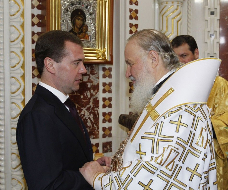 Russia&#039;s President Medvedev greets Patriarch of Moscow and All Russia Kirill as they attend an Orthodox Christmas Mass in Moscow
