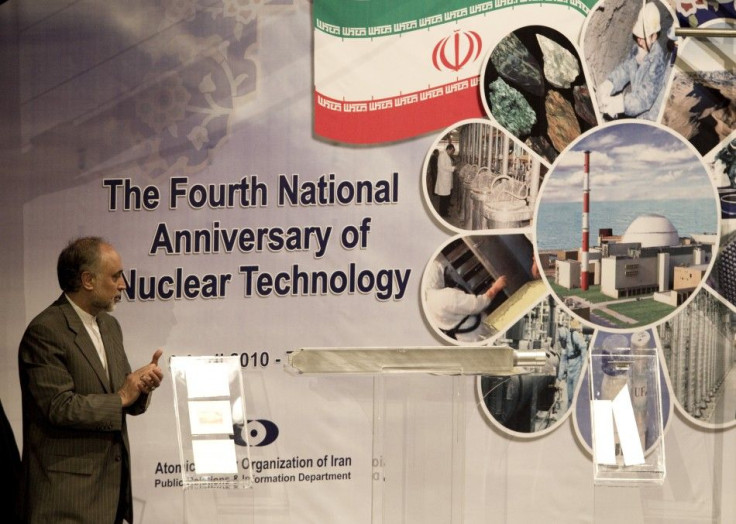 Ali Akbar Salehi, head of Iran's Atomic Energy Organisation, claps as he looks at an object representing nuclear fuel which will be used in Tehran's research reactor during a ceremony to mark the Fourth National Anniversary of Nuclear Technology