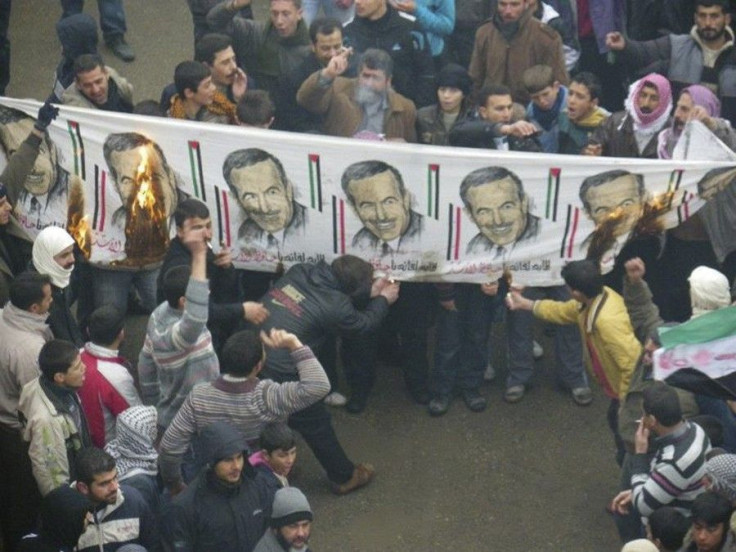 Demonstrators burn images of Syria's late President Hafez Al Assad, to protest against Syria's President Bashar al-Assad after Friday prayers in Idleb, January 6, 2012. Picture taken January 6, 2012.