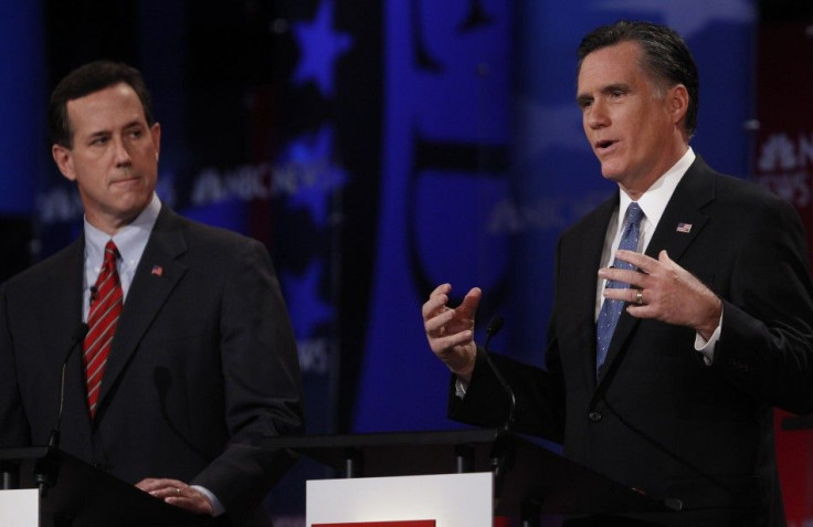 Republican presidential candidates (L-R) former U.S. Senator Rick Santorum (R-PA) listens as former Massachusetts Governor Mitt Romney speaks during the Republican presidential candidates debate in Concord, New Hampshire, January 8, 2012.