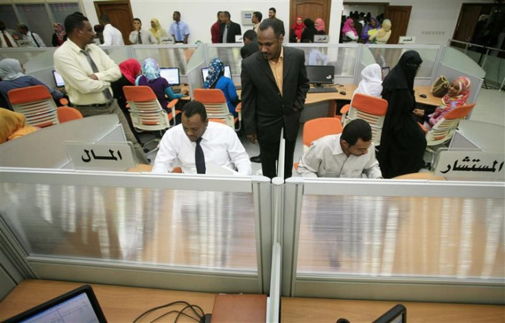 Traders work during the opening of the new electronic trading Khartoum Stock Exchange