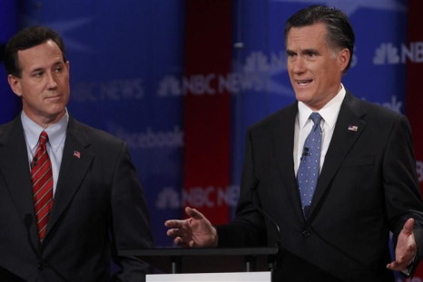 Republican presidential candidate Santorum listens as Romney speaks 