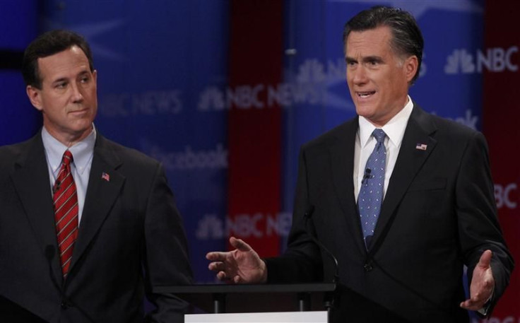Republican presidential candidate Santorum listens as Romney speaks