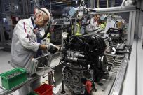 Employees of French carmaker PSA Peugeot Citroen work on the new engine &quot;EB&quot; assembly line at the company engines factory in Tremery near Metz